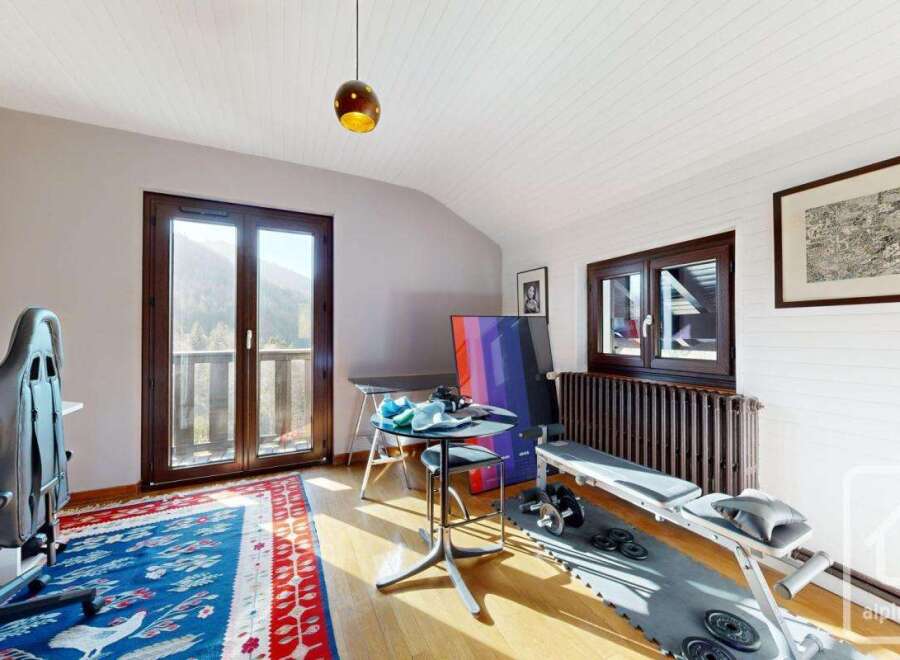 This stunning property boasts a versatile room that seamlessly blends a home office and a gym.