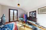 This stunning property boasts a versatile room that seamlessly blends a home office and a gym.