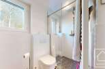 This modern bathroom boasts a walk-in shower with glass enclosure and a stylish toilet.