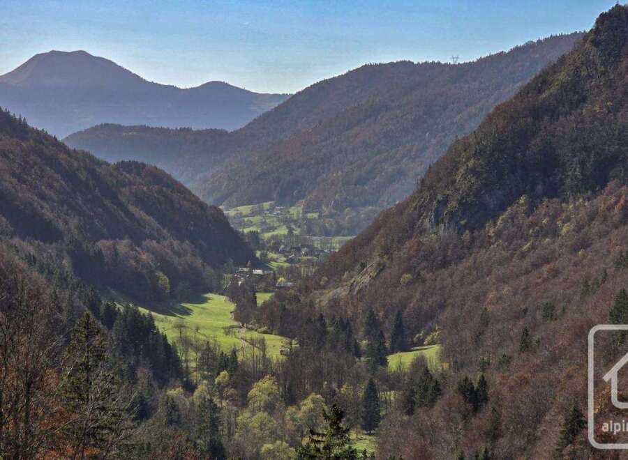 Nestled in a serene valley, this property offers breathtaking views of majestic mountains and lush greenery.