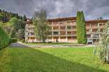 This stunning apartment building boasts a picturesque setting, nestled amidst lush greenery and offering breathtaking views.