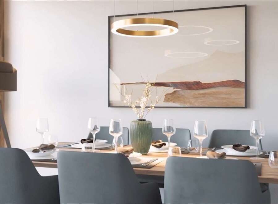 Modern dining room with stylish gray chairs and a light wood table.