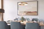 Modern dining room with stylish gray chairs and a light wood table.