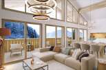 Luxurious chalet apartment boasting breathtaking mountain views and a spacious open-plan living area.