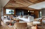 This stunning chalet boasts a spacious open-plan living area with a cozy and inviting atmosphere.