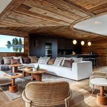 This stunning chalet boasts a spacious open-plan living area with a cozy and inviting atmosphere.