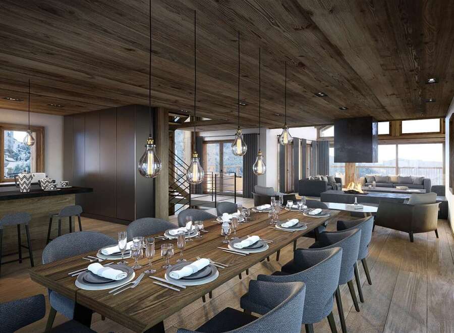 This stunning chalet boasts a spacious open-plan living area with a cozy fireplace, perfect for entertaining guests.
