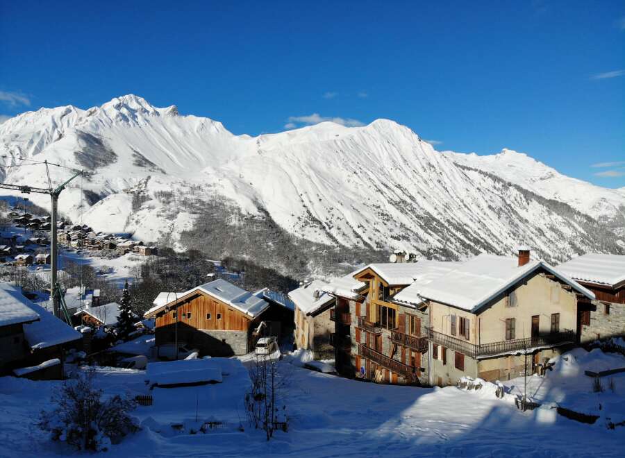This stunning chalet boasts breathtaking mountain views and is nestled in a charming snow-covered village.