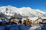 This stunning chalet boasts breathtaking mountain views and is nestled in a charming snow-covered village.