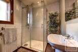 This stunning bathroom boasts a spacious walk-in shower with glass doors and modern fixtures.