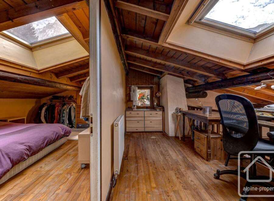 This charming attic space boasts a unique blend of rustic charm and modern functionality.