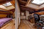 This charming attic space boasts a unique blend of rustic charm and modern functionality.