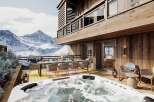 Luxury chalet with breathtaking mountain views, featuring a private outdoor hot tub and spacious deck perfect for entertaining.
