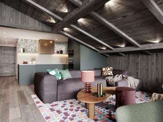 This stunning attic apartment boasts a cozy living area with a plush sectional sofa, complemented by a unique coffee table and a colorful rug.