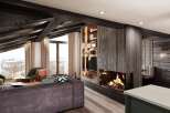 This stunning chalet boasts a spacious open-plan living area with a cozy fireplace, perfect for relaxing after a day on the slopes.