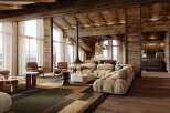 This stunning chalet boasts a spacious open-plan living area with floor-to-ceiling windows offering breathtaking mountain views, a cozy fireplace, and luxurious furnishings.