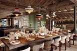This stunning chalet boasts a spacious dining area with a long wooden table, perfect for gatherings.