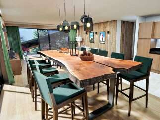 Experience luxury living in this stunning property, featuring a spacious dining area with a unique live-edge table and stylish seating.