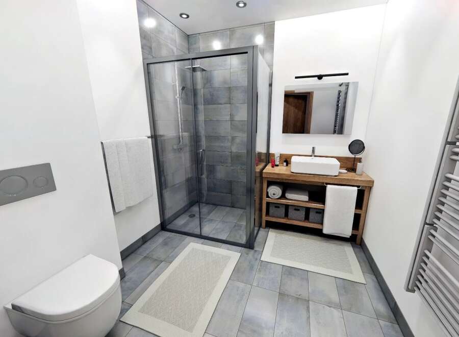 Step into a modern bathroom oasis! This stunning space features a sleek glass shower, a stylish wooden vanity, and elegant tile flooring.