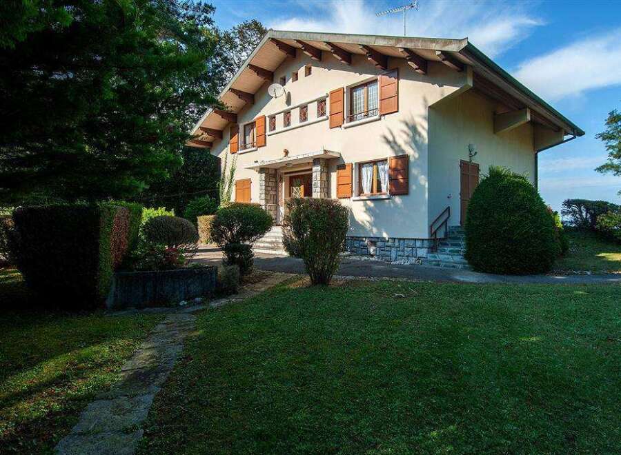Charming house nestled in a lush green landscape, offering tranquility and privacy.