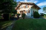 Charming house nestled in a lush green landscape, offering tranquility and privacy.