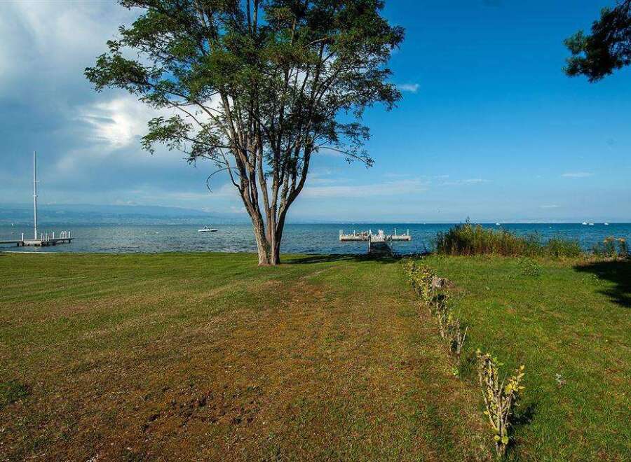 Lakefront property with private dock and expansive lawn.