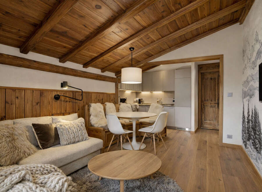 Experience the charm of this cozy living space, featuring a warm wooden ceiling and inviting wooden floors.