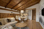 Experience the charm of this cozy living space, featuring a warm wooden ceiling and inviting wooden floors.