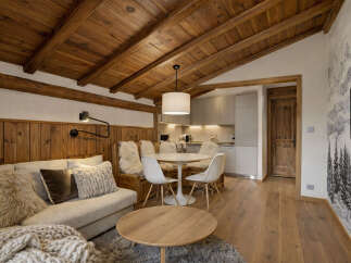 Experience the charm of this cozy living space, featuring a warm wooden ceiling and inviting wooden floors.