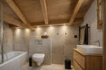 This stunning bathroom features a rustic design with exposed wooden beams and a modern touch.