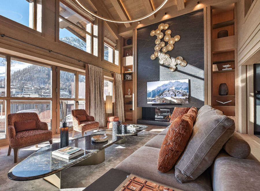 Experience luxury living in this stunning property, featuring expansive windows that frame breathtaking mountain views.