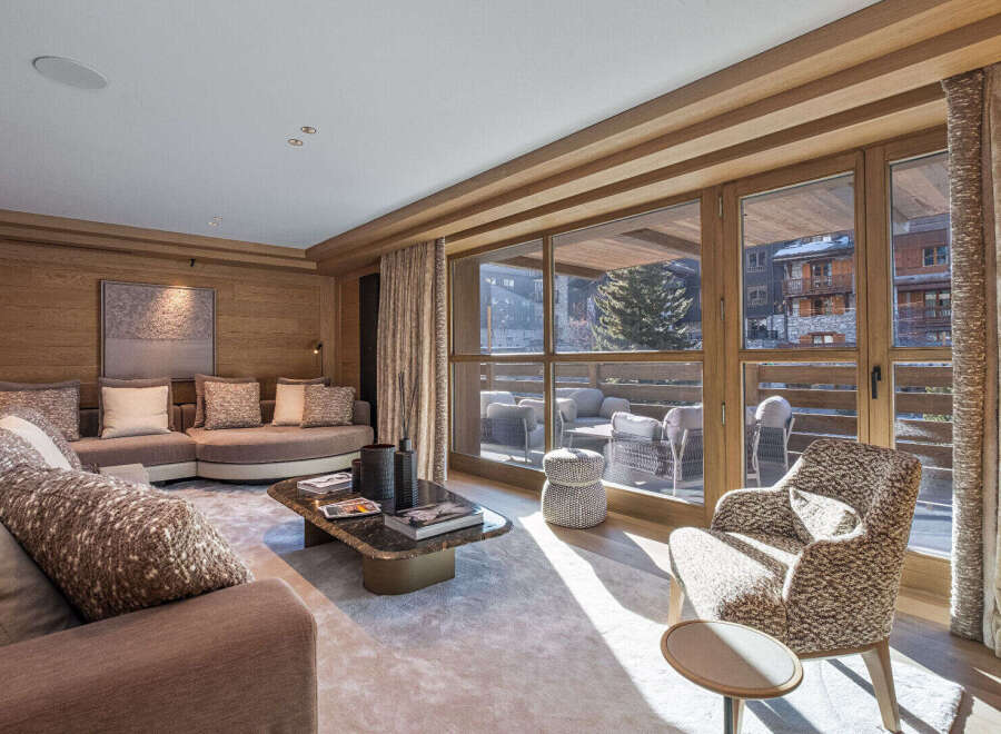 Experience luxury living in this stunning property, featuring a beautifully designed living room with a cozy seating area and a modern coffee table.