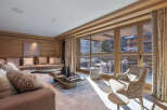 Experience luxury living in this stunning property, featuring a beautifully designed living room with a cozy seating area and a modern coffee table.