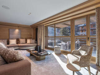 Experience luxury living in this stunning property, featuring a beautifully designed living room with a cozy seating area and a modern coffee table.