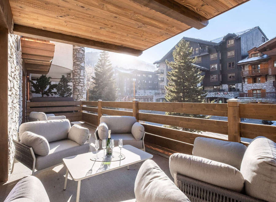 Enjoy breathtaking mountain views from this luxurious outdoor seating area.