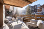 Enjoy breathtaking mountain views from this luxurious outdoor seating area.