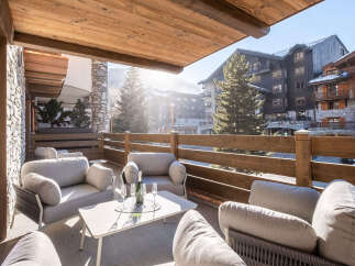 Enjoy breathtaking mountain views from this luxurious outdoor seating area.
