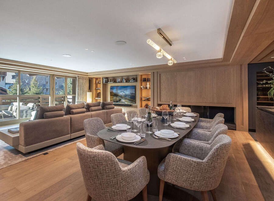 Experience luxury living in this stunning property, featuring a spacious living area with a modern dining setup.