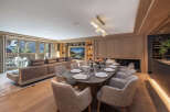 Experience luxury living in this stunning property, featuring a spacious living area with a modern dining setup.