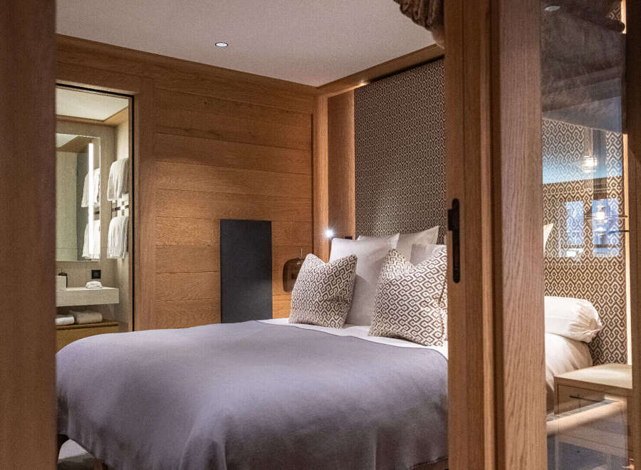Step into luxury with this stunning bedroom, featuring exquisite wooden paneling and a serene ambiance.