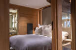 Step into luxury with this stunning bedroom, featuring exquisite wooden paneling and a serene ambiance.