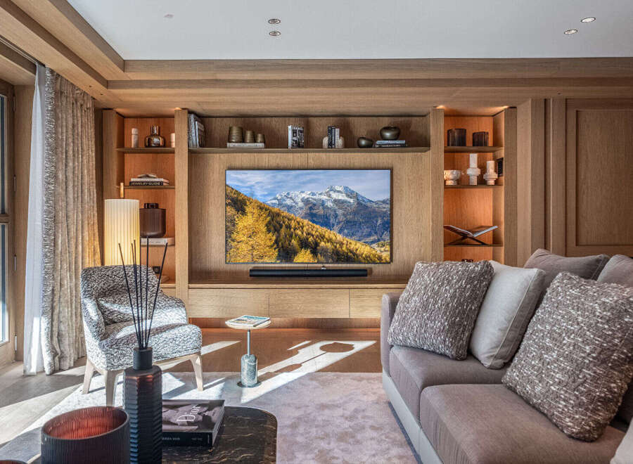Experience luxury living in this stunning property, featuring a beautifully designed living room with a modern entertainment center.