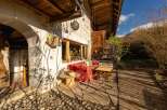 Rustic stone house with charming outdoor patio, perfect for relaxing and enjoying the mountain views.