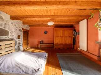 Rustic charm meets modern comfort in this unique bedroom.