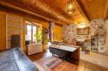 Rustic bathroom with exposed wooden beams, terracotta tile flooring, and a clawfoot bathtub.