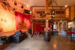 Rustic-chic venue with a stage, lofted area, and exposed beams.