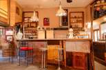 Rustic-chic bar with eclectic decor and reclaimed wood features.