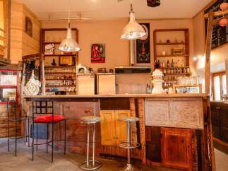 Rustic-chic bar with eclectic decor and reclaimed wood features.