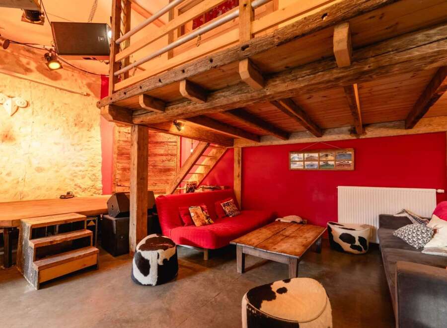 Rustic-chic barn conversion with exposed beams and a mezzanine level.