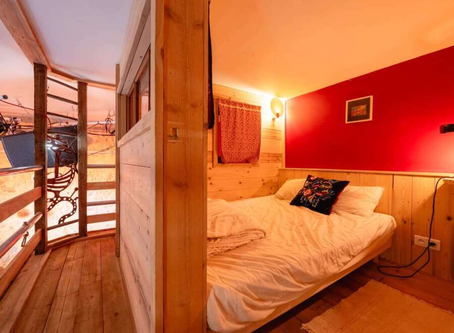 Cozy cabin bedroom with a unique wooden design and a comfortable bed.